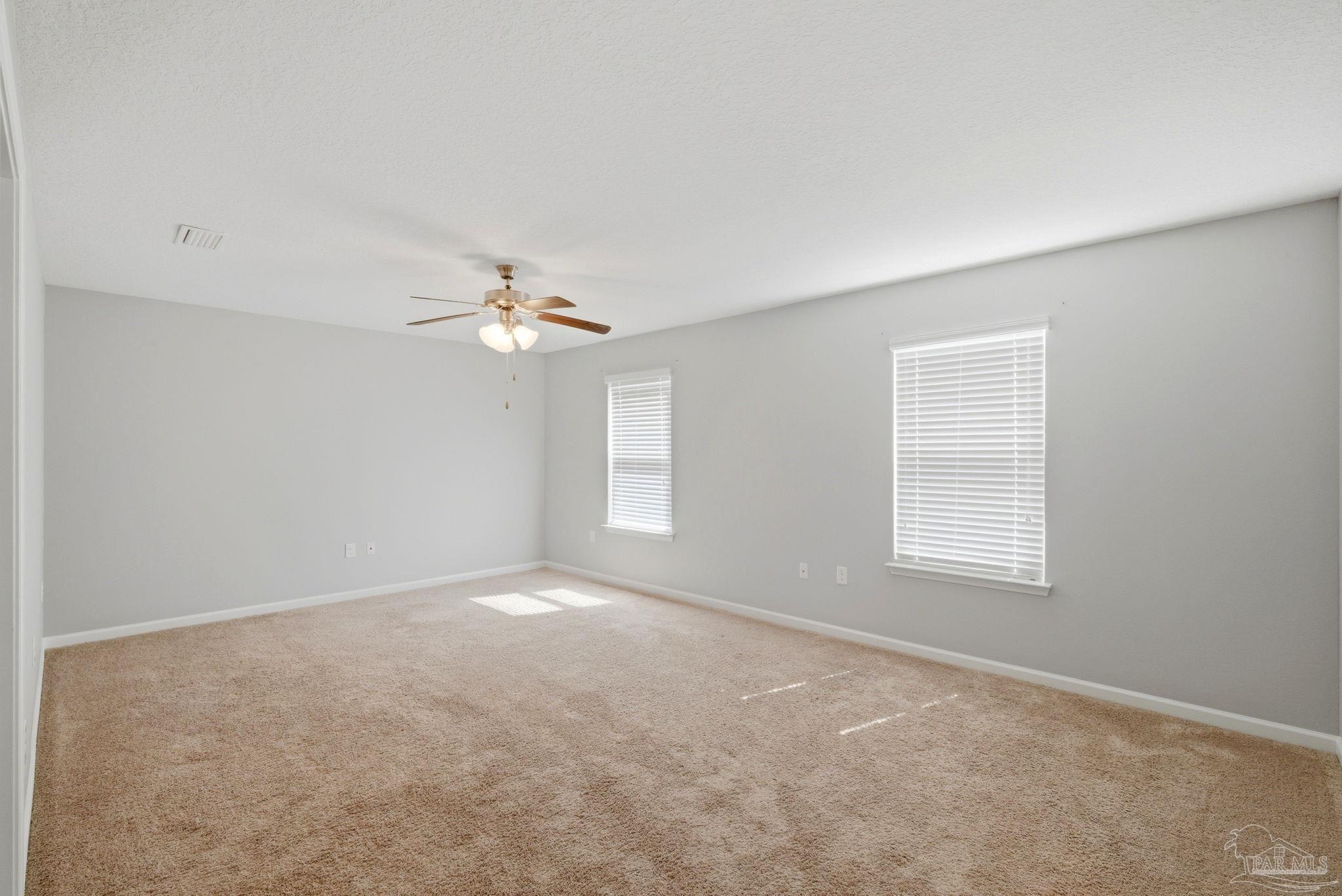 5881 Bay Tree Court Milton, FL 32570 - Photo 15 of 51 an empty room with a window and a fan