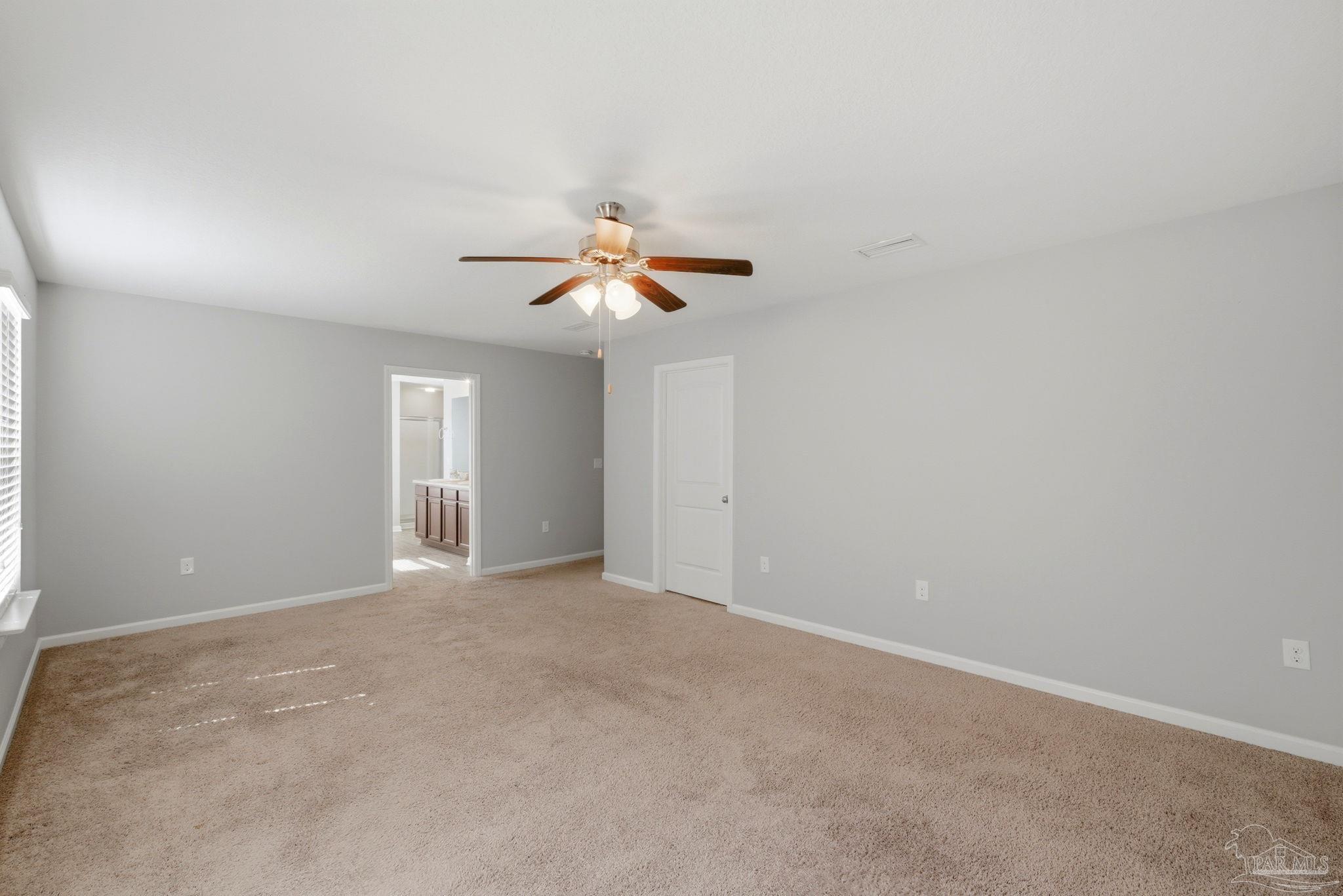 5881 Bay Tree Court Milton, FL 32570 - Photo 16 of 51 an empty room with windows and fan