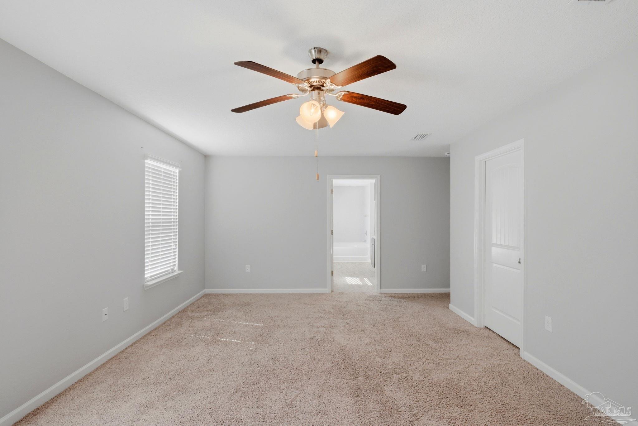 5881 Bay Tree Court Milton, FL 32570 - Photo 17 of 51 a view of an empty room with window and cabinet