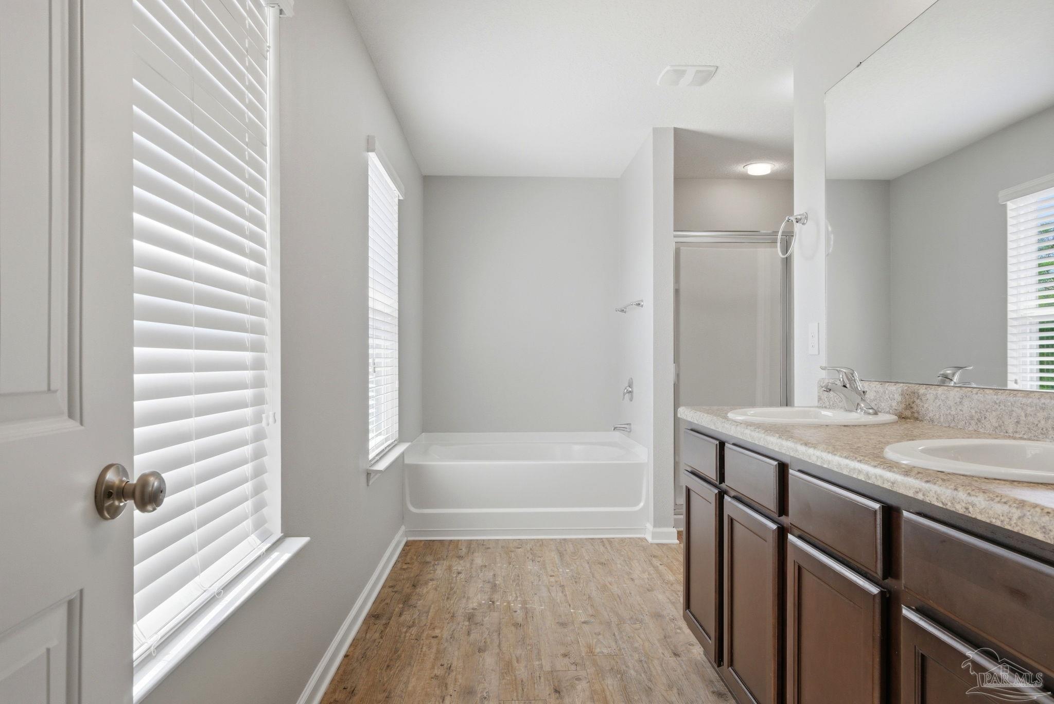 5881 Bay Tree Court Milton, FL 32570 - Photo 19 of 51 a bathroom with a tub sink and mirror