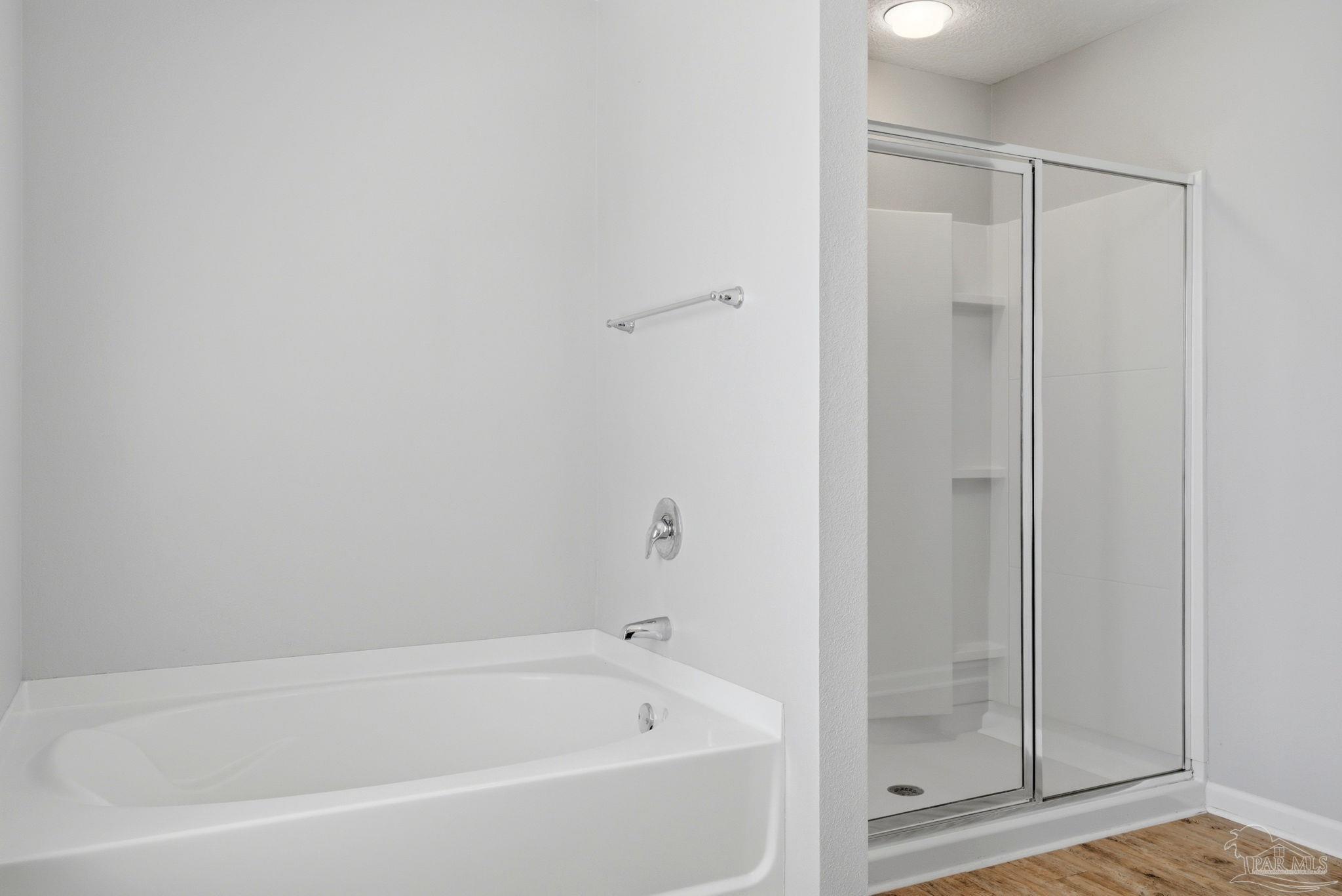 5881 Bay Tree Court Milton, FL 32570 - Photo 20 of 51 a white bath tub sitting next to a shower