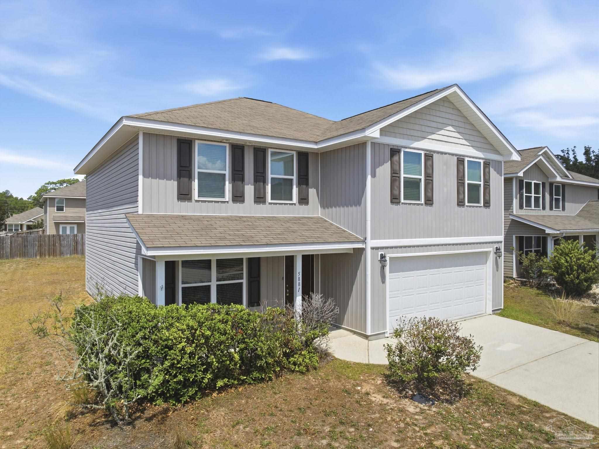 5881 Bay Tree Court Milton, FL 32570 - Photo 2 of 51 a front view of a house with a yard