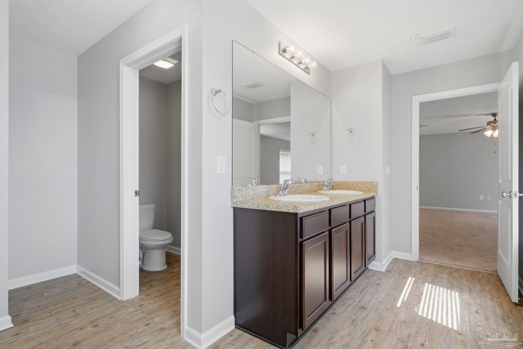 5881 Bay Tree Court Milton, FL 32570 - Photo 21 of 51 a bathroom with a sink a toilet and shower