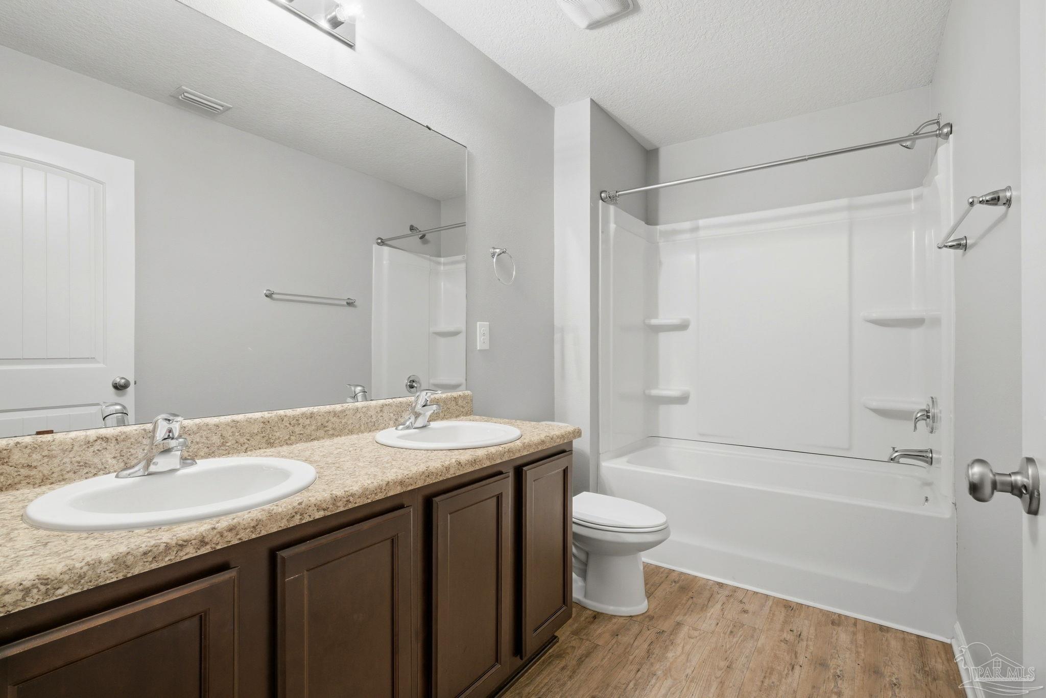 5881 Bay Tree Court Milton, FL 32570 - Photo 28 of 51 a bathroom with a granite countertop sink toilet and shower