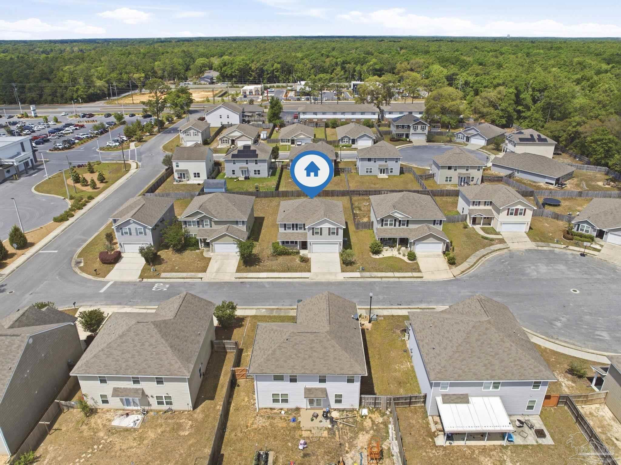 5881 Bay Tree Court Milton, FL 32570 - Photo 33 of 51 an aerial view of residential houses with outdoor space and parking