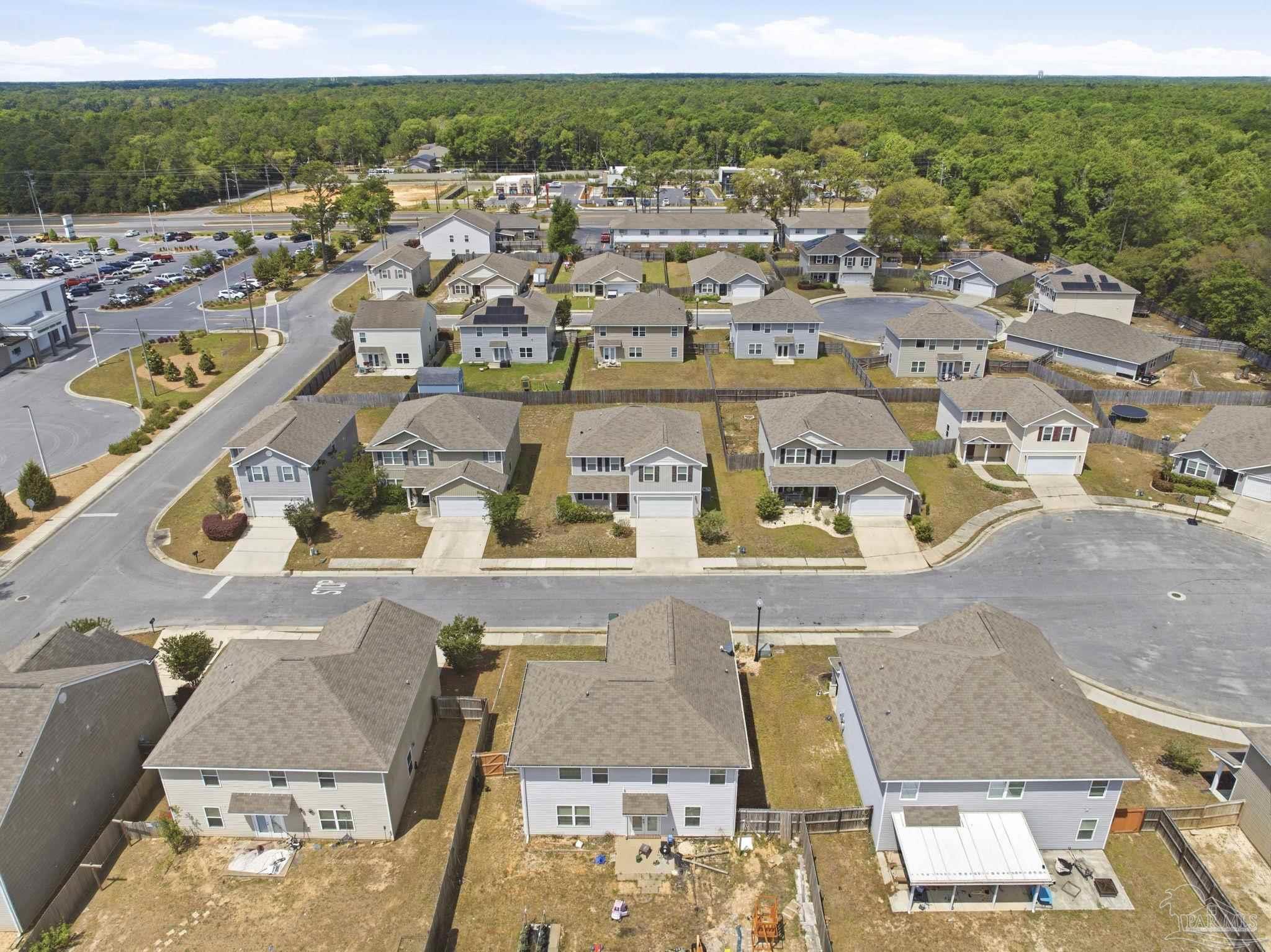 5881 Bay Tree Court Milton, FL 32570 - Photo 34 of 51 an aerial view of residential houses with outdoor space