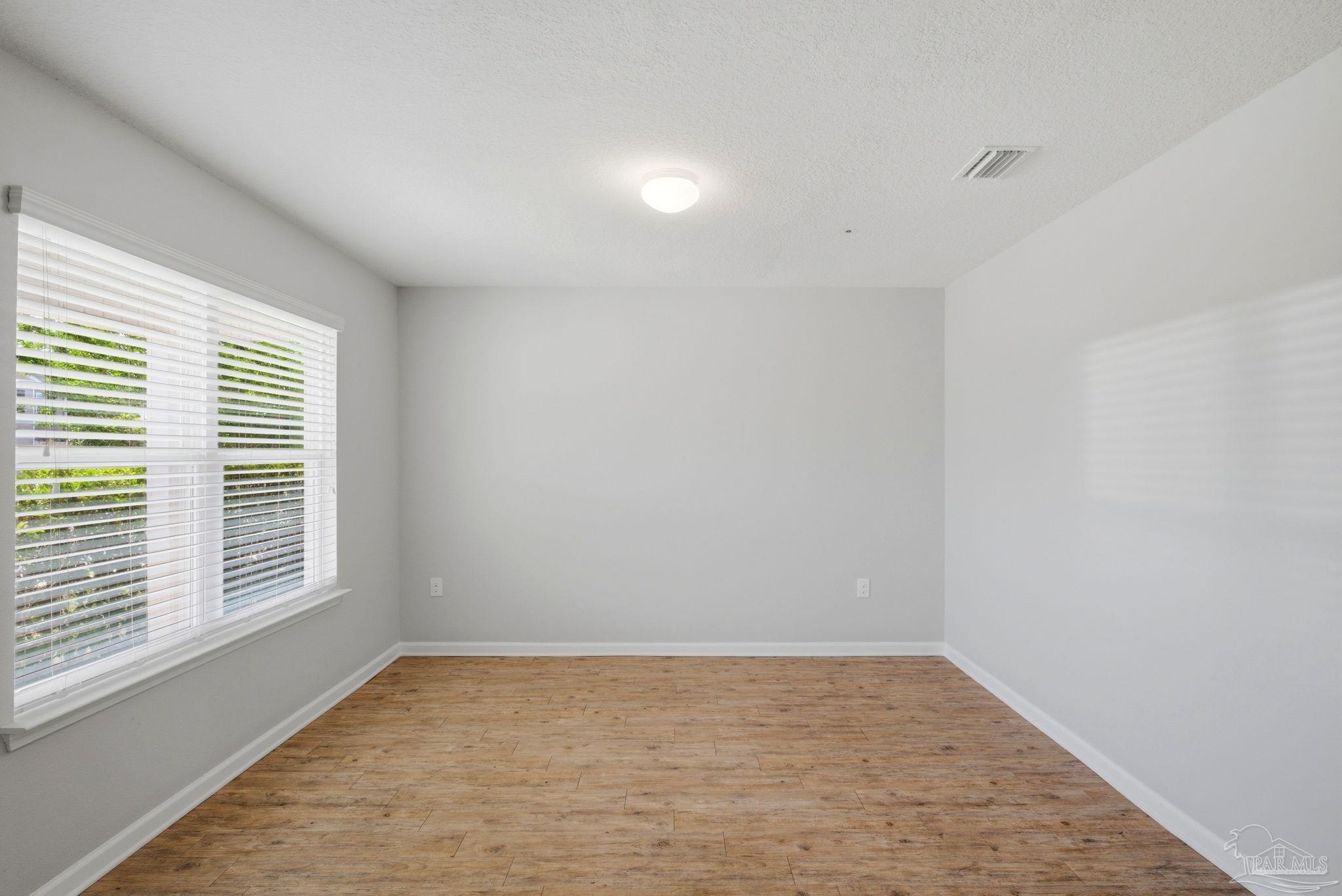 5881 Bay Tree Court Milton, FL 32570 - Photo 6 of 51 a view of an empty room with a window