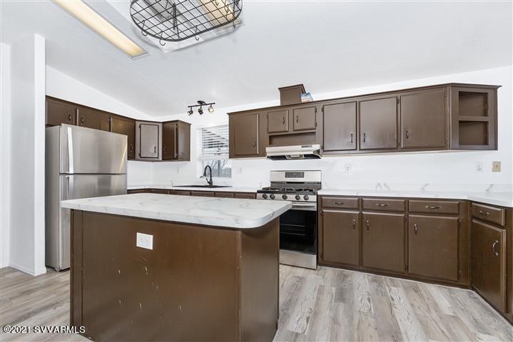 4120 East Beaver Creek Road Rimrock, AZ 86335 - Photo 11 of 31 a kitchen with kitchen island granite countertop a sink stove and refrigerator
