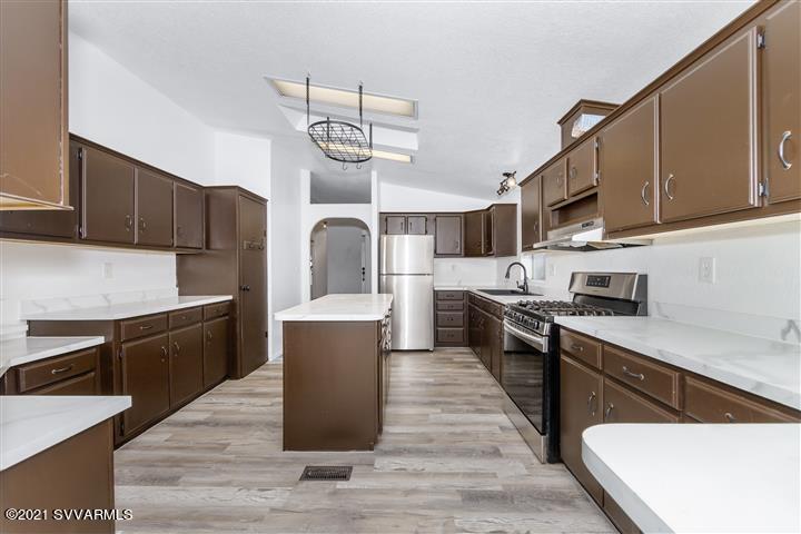 4120 East Beaver Creek Road Rimrock, AZ 86335 - Photo 13 of 31 a kitchen with stainless steel appliances granite countertop a sink a stove and a wooden floors