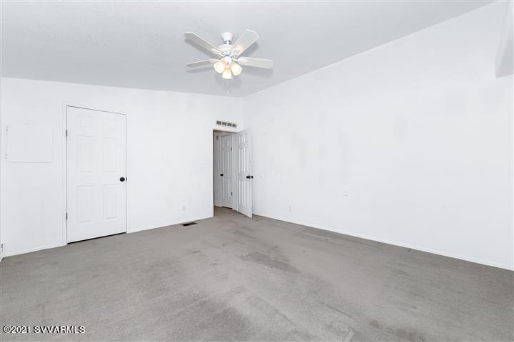 4120 East Beaver Creek Road Rimrock, AZ 86335 - Photo 17 of 31 an empty room with a chandelier fan