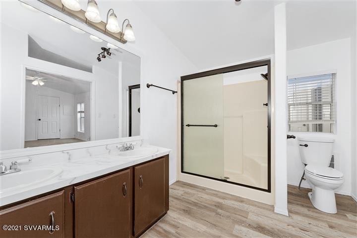 4120 East Beaver Creek Road Rimrock, AZ 86335 - Photo 19 of 31 a bathroom with a sink mirror vanity and toilet