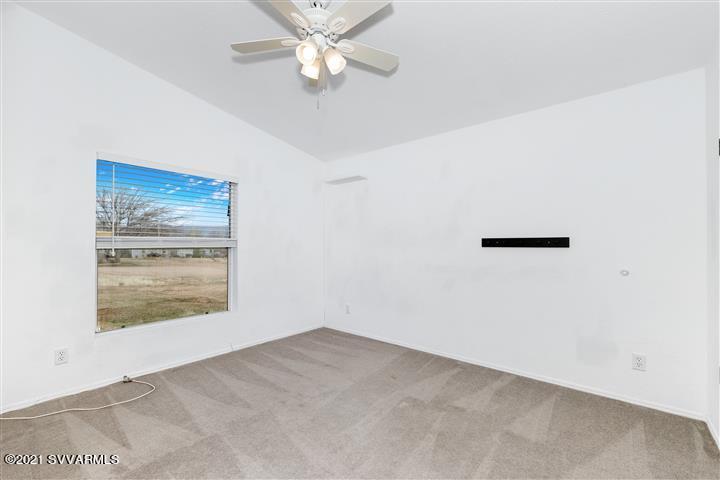 4120 East Beaver Creek Road Rimrock, AZ 86335 - Photo 20 of 31 an empty room with a window and ceiling fan