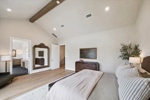 a bedroom with bed and a flat screen tv