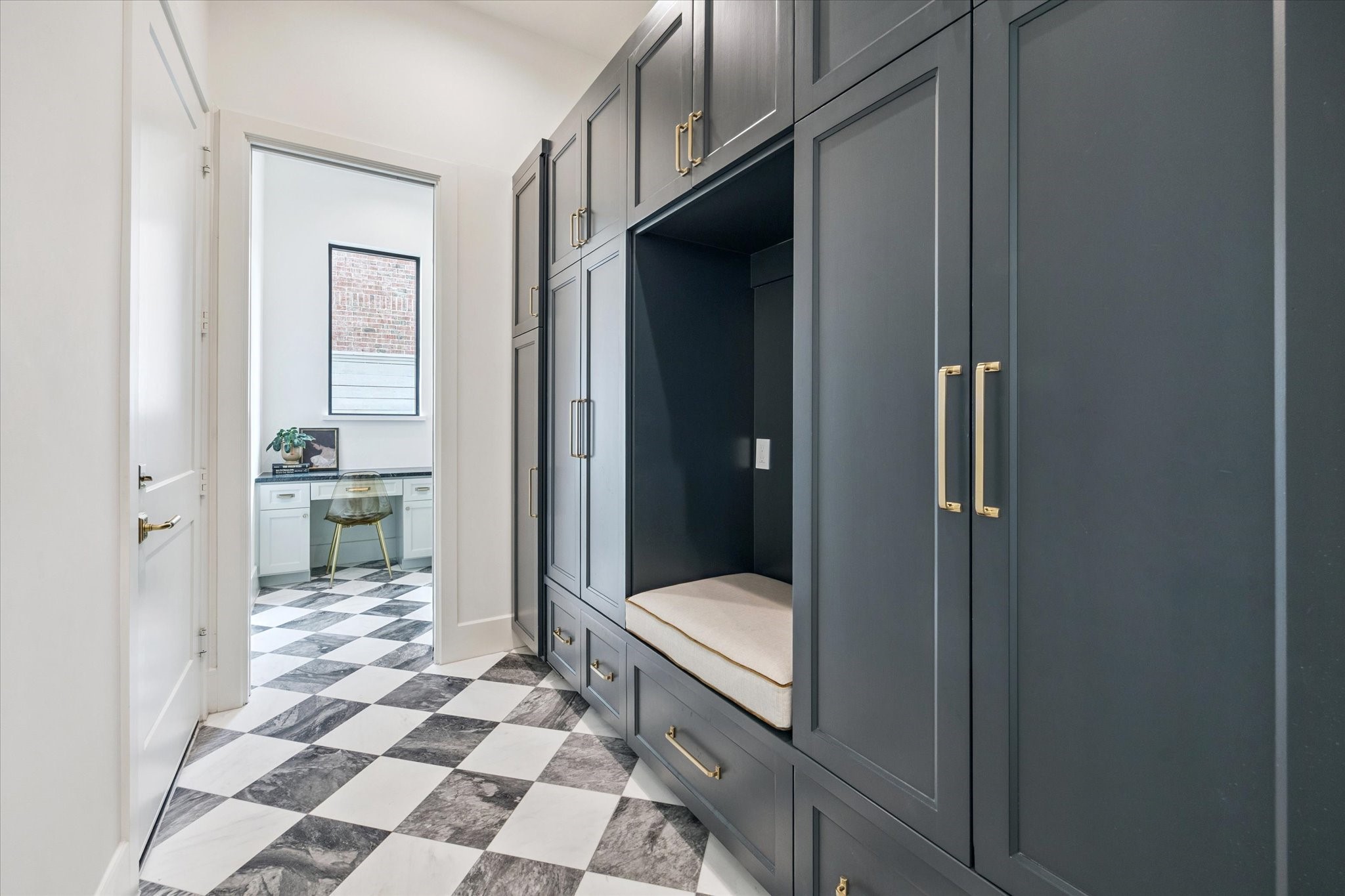 2823 Plumb Street Houston, TX 77005 - Photo 16 of 16 Chic and smart - this custom mudroom offers ample storage where each family member can personalize their own dropzone, with a built-in bench. Also shown here is an optional adjacent workstation ideal for homework or household management. The current floorplan offers the downstairs (full) bathroom here in place of a workstation.
*Photos shown are examples of the builder’s previously completed homes and may include optional or upgraded features.