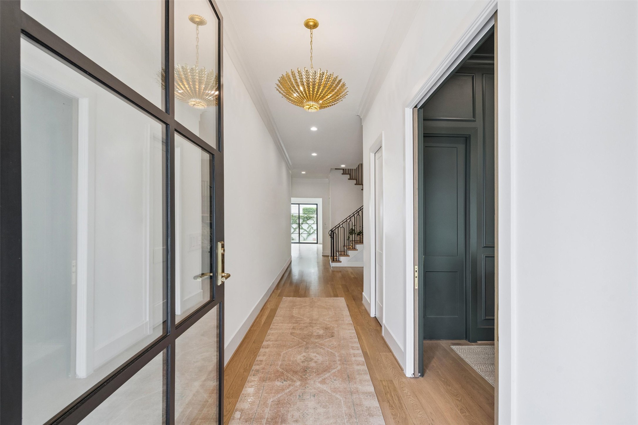 2823 Plumb Street Houston, TX 77005 - Photo 2 of 16 Step through a stunning glass-paned door into a bright, welcoming foyer with high 11' ceilings, designer lighting and 5" white oak hardwood floors throughout - a sample of the sophisticated entryway style this builder is known for.
*Photos shown are examples of the builder’s previously completed homes and may include optional or upgraded features.