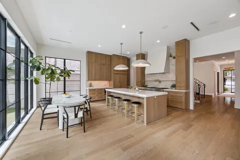 a large kitchen with a table and chairs in it
