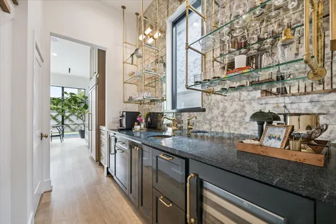 a kitchen with stainless steel appliances granite countertop a sink a stove and cabinets