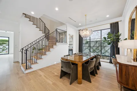 a dining room with furniture window and wooden floor