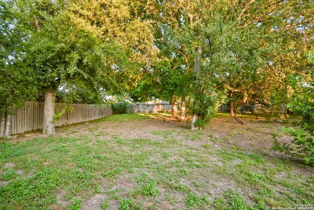a backyard of a house with a trees