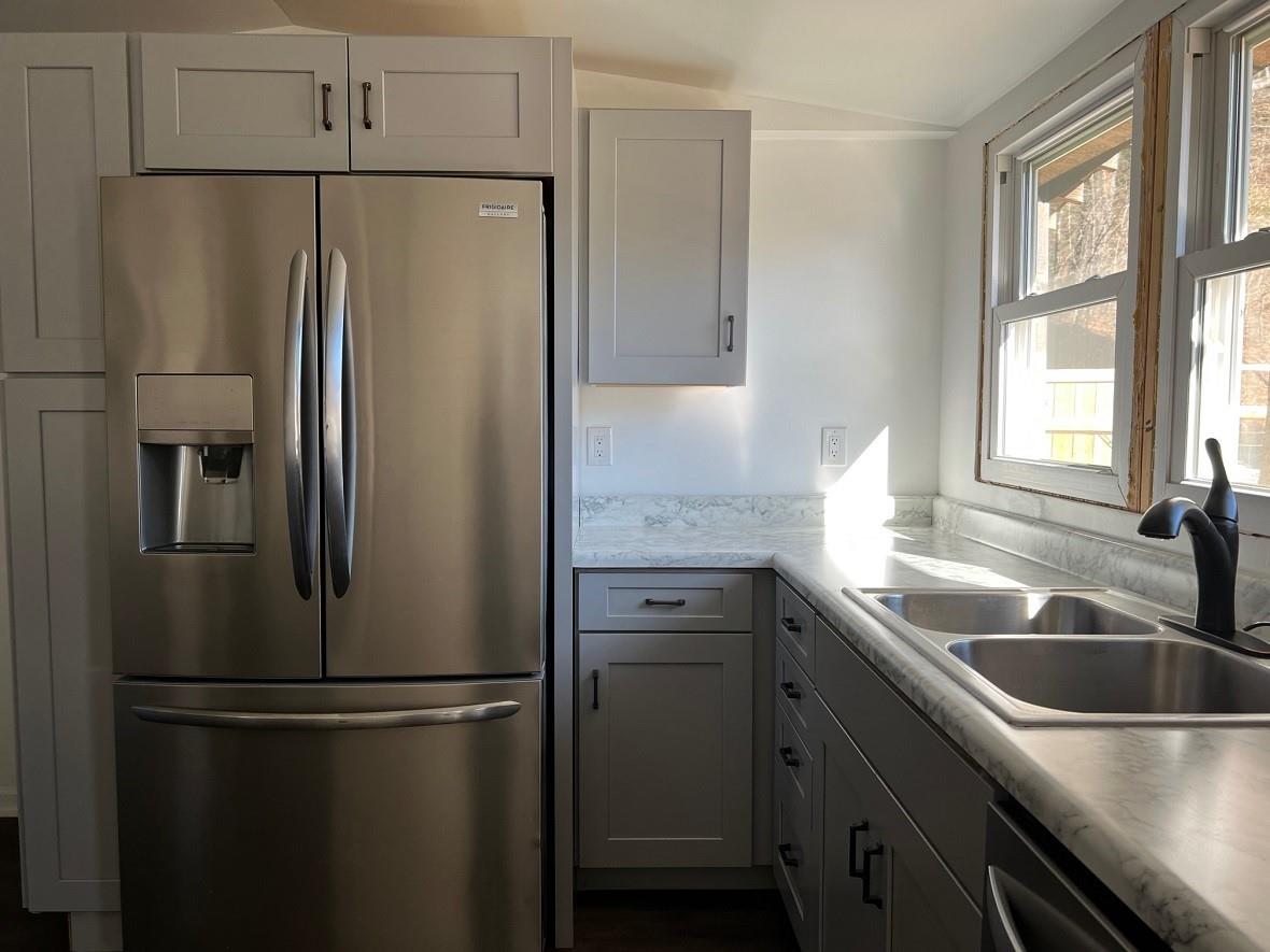 1363 Henry Road Sylva, NC 28779 - Photo 3 of 33 a kitchen with stainless steel appliances a refrigerator sink and cabinets