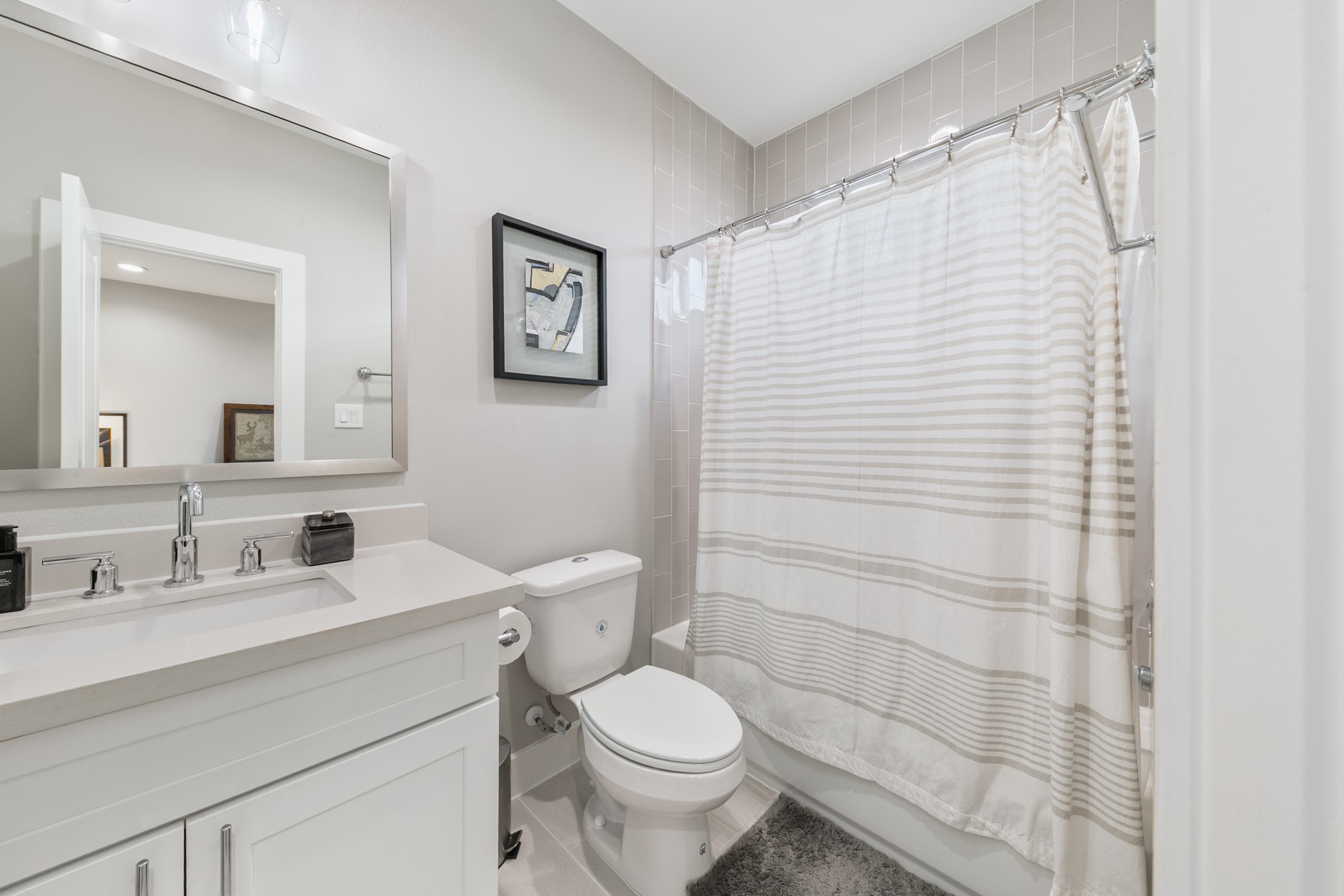 4032 Buck Street, Unit A Houston, TX 77020 - Photo 33 of 39 a bathroom with a sink a toilet and shower curtain