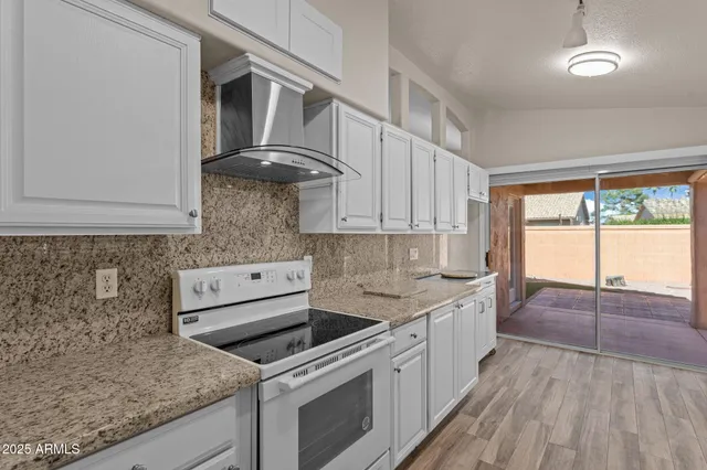 a kitchen with stainless steel appliances granite countertop a sink stove and cabinets