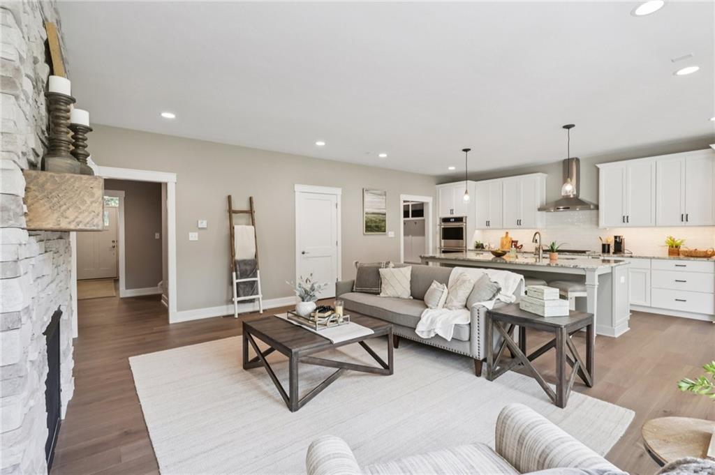 102 Bartlett Lane Wexford, PA 15090 - Photo 13 of 40 a living room with fireplace furniture and a view of kitchen