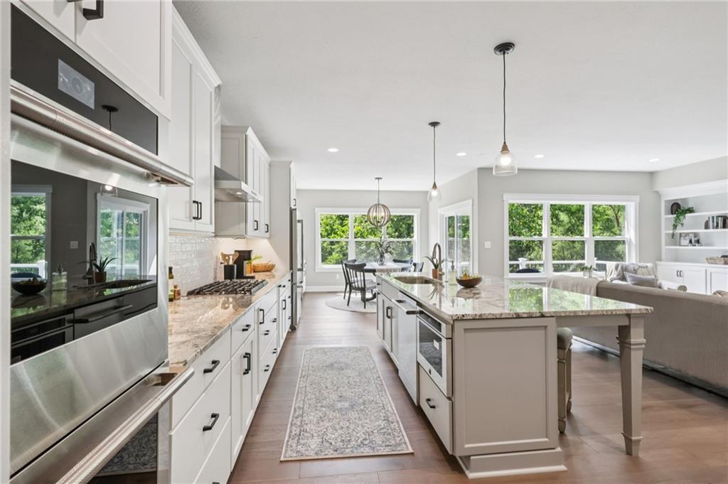 102 Bartlett Lane Wexford, PA 15090 - Photo 17 of 40 a large kitchen with kitchen island a large window a sink and stainless steel appliances