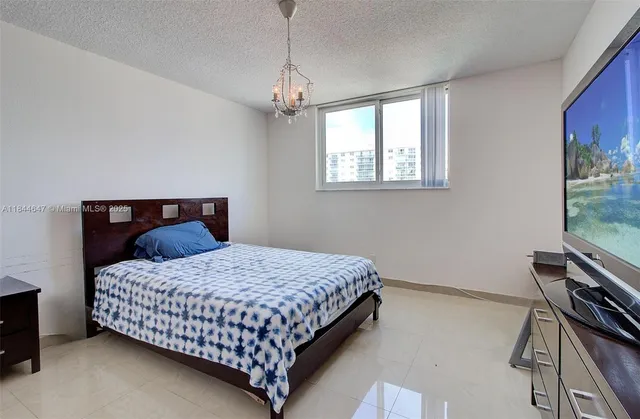 a bathroom with a sink a toilet a mirror a vanity and shower
