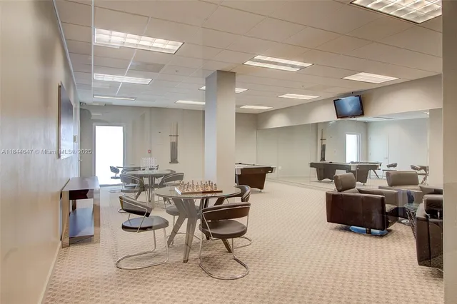 a work room with furniture and large windows