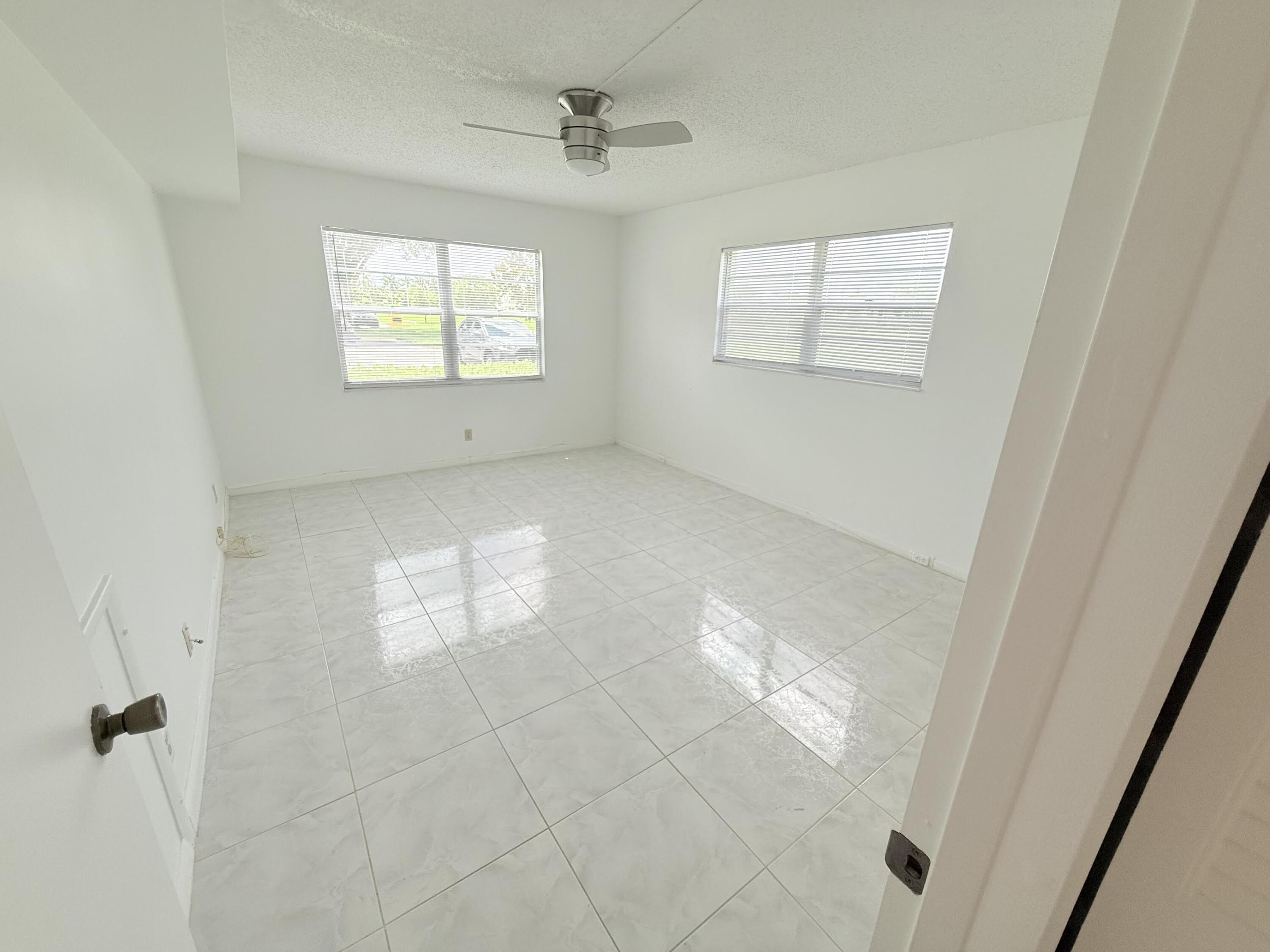 1036 Hythe B, Unit B Boca Raton, FL 33434 - Photo 18 of 53 a view of empty room with windows