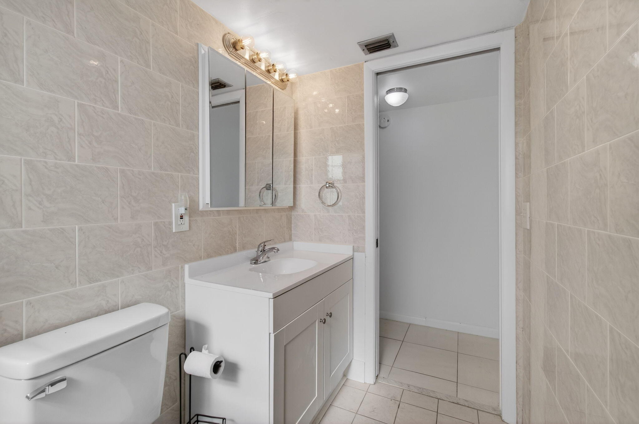 1036 Hythe B, Unit B Boca Raton, FL 33434 - Photo 22 of 53 a bathroom with a sink toilet and shower