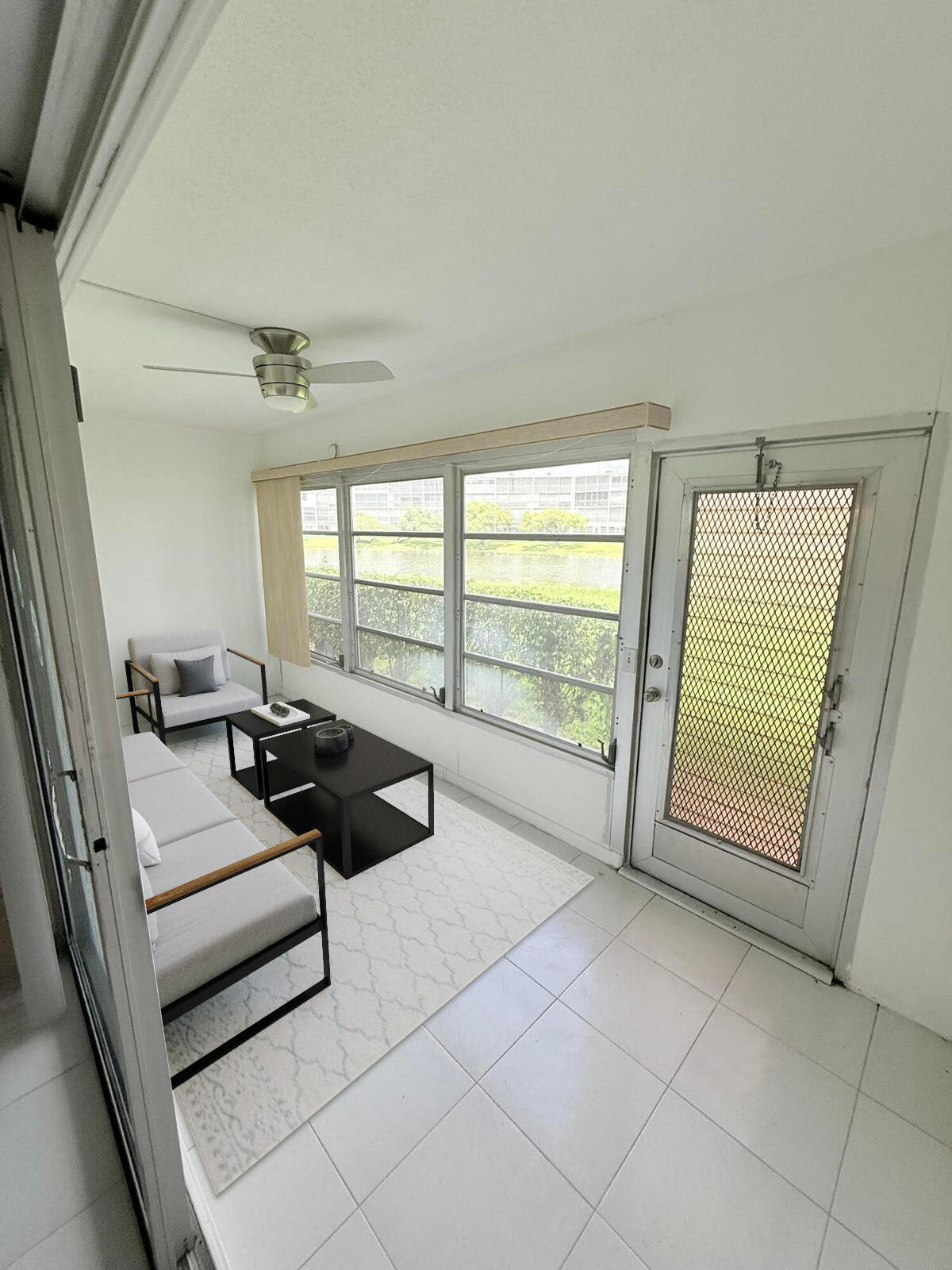 1036 Hythe B, Unit B Boca Raton, FL 33434 - Photo 25 of 53 a living room with furniture and a floor to ceiling window