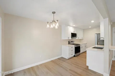 a kitchen that has a sink and a stove top oven