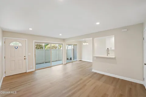 a view of an empty room with glass door