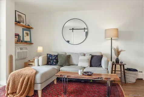 a living room with furniture and a lamp