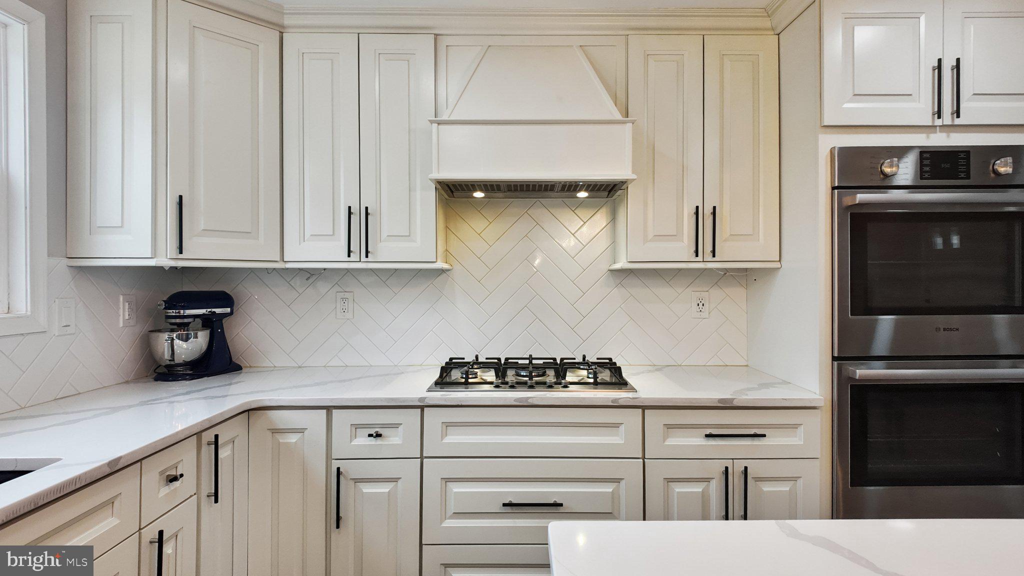 94 Sioux Road Doylestown, PA 18901 - Photo 11 of 33 a kitchen with white cabinets and appliances
