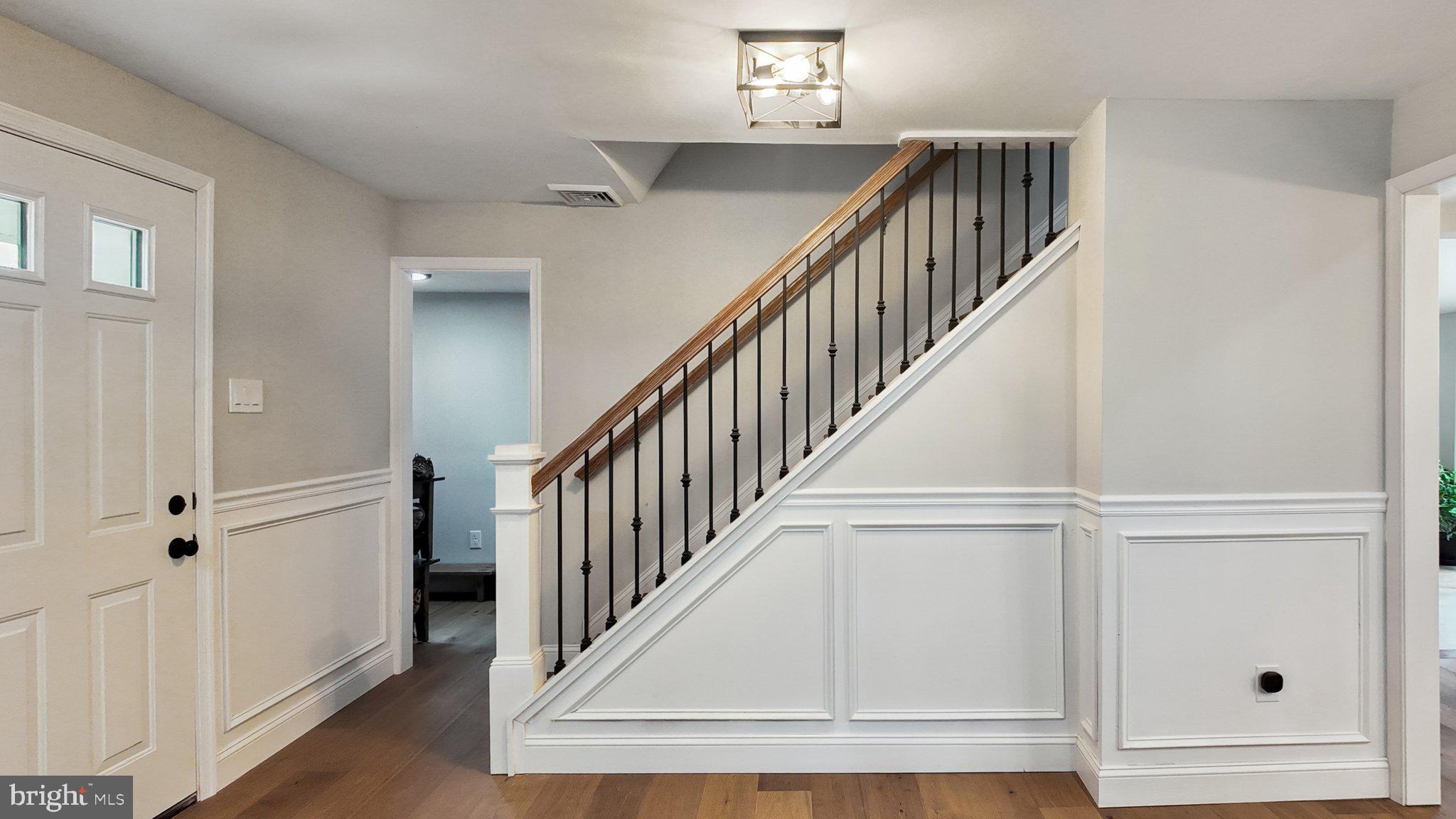 94 Sioux Road Doylestown, PA 18901 - Photo 18 of 33 a view of staircase with wooden floor and fan