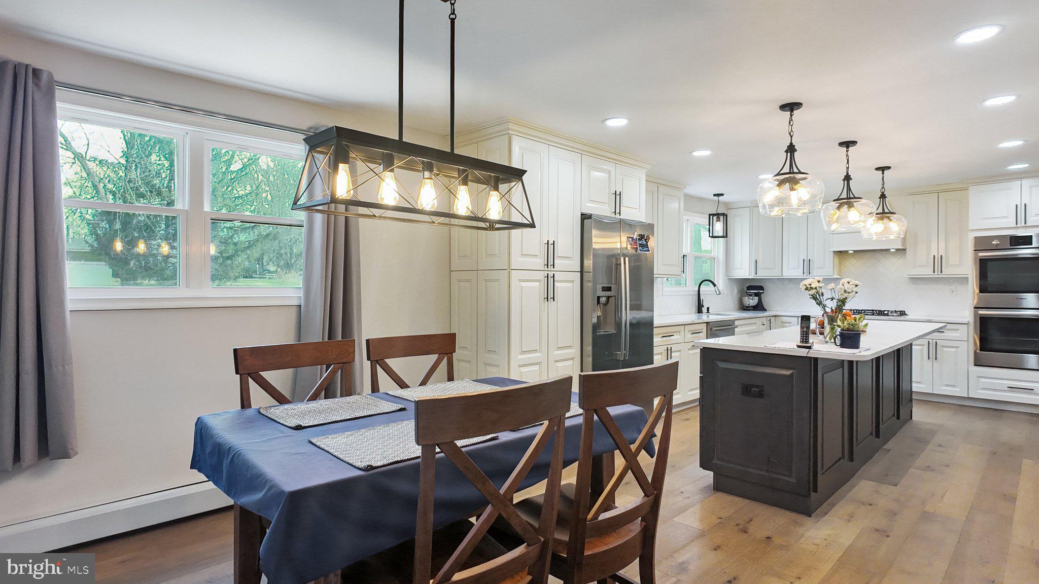 94 Sioux Road Doylestown, PA 18901 - Photo 6 of 33 a kitchen with stainless steel appliances a dining table chairs and refrigerator