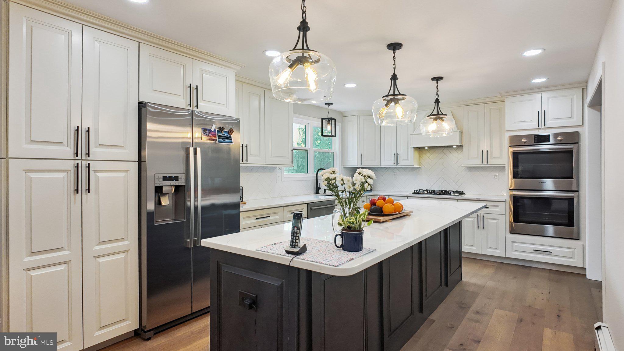 94 Sioux Road Doylestown, PA 18901 - Photo 7 of 33 a kitchen with stainless steel appliances granite countertop a sink refrigerator and cabinets