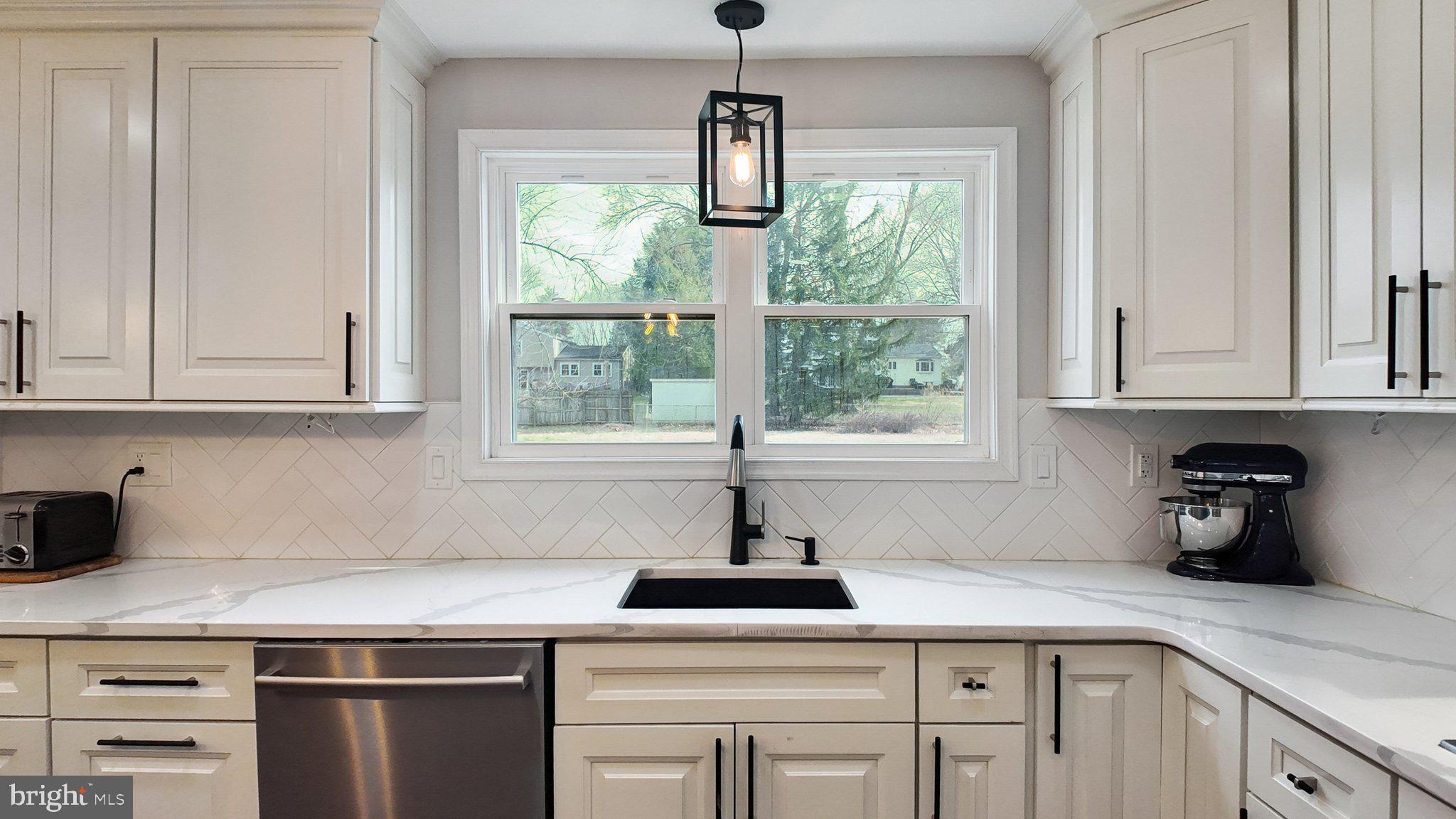 94 Sioux Road Doylestown, PA 18901 - Photo 9 of 33 a kitchen with appliances cabinets and a window