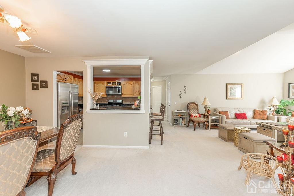 100 Genoble Road Montville, NJ 07045 - Photo 5 of 18 a living room with furniture and a dining table with wooden floor