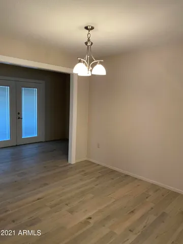 a view of a room with wooden floor and windows