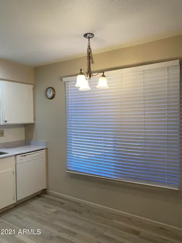 a view of a room with wooden floor and white walls