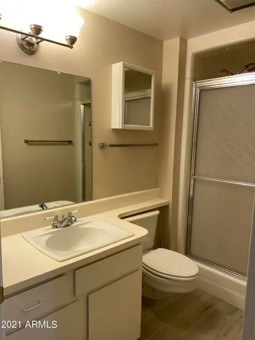 a bathroom with a sink toilet and shower