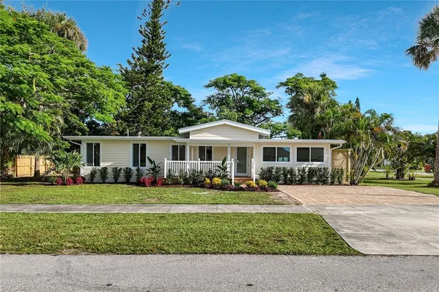 a front view of a house with a garden