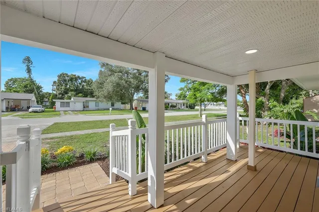 a view of a balcony with floor to ceiling windows wooden floor