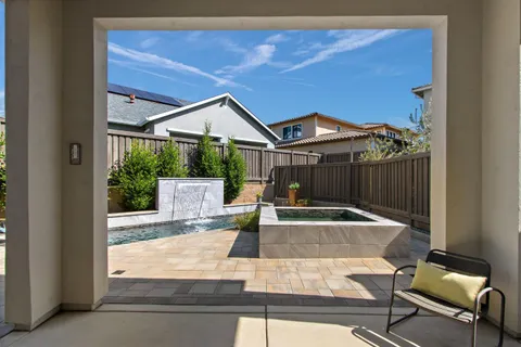 a view of a house with backyard and sitting area