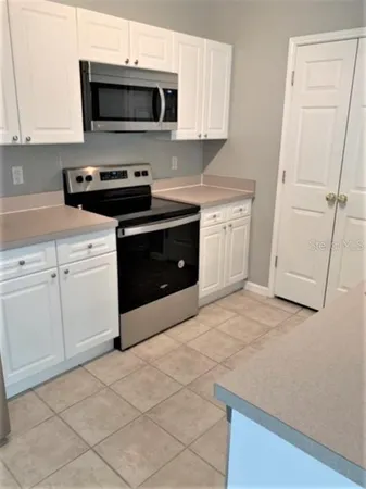 a kitchen with stainless steel appliances white cabinets and a stove