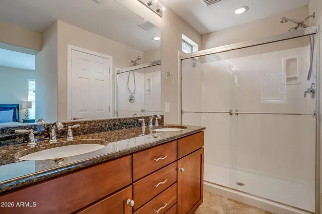 a bathroom with a granite countertop sink mirror and double